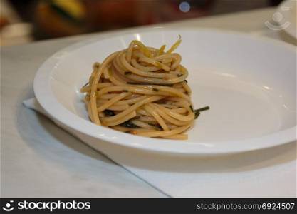 Spaghetti with Sauce and Herbs, Cooked Italian Pasta in White Plastic Plate