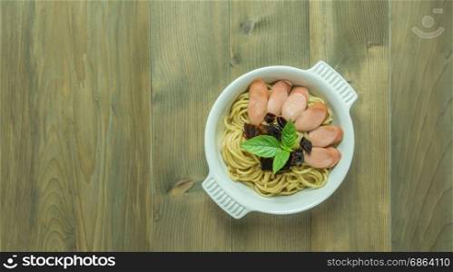 Spaghetti with sausage and dried peppers. Spaghetti with sausage and dried peppers , hot and spicy on wooden background, top view