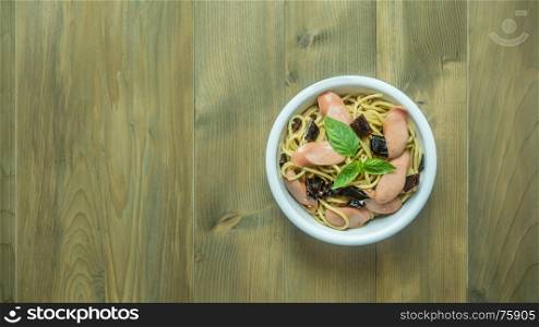 Spaghetti with sausage and dried peppers. Spaghetti with sausage and dried peppers , hot and spicy on wooden background, top view