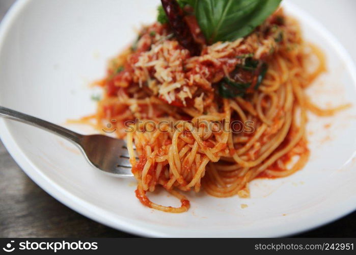 Spaghetti with tomato sauce and fresh basil on wood , Italian pasta