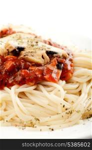 Spaghetti with tomato souce and champignons on white plate