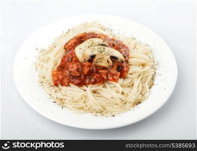 Spaghetti with tomato souce and champignons on white plate