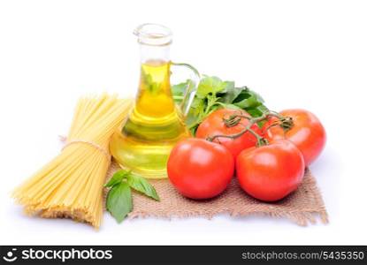 Spaghetti with tomatoes, olive oil and basil on a sacking isolated on white