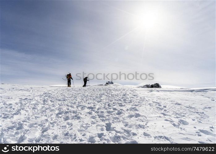 Spain, Andalusia, Granada. Ski resort of Sierra Nevada in winter, full of snow, with unrecognizable people doing cross-country skiing. Travel and sports concepts.. People doing cross-country skiing in Sierra Nevada