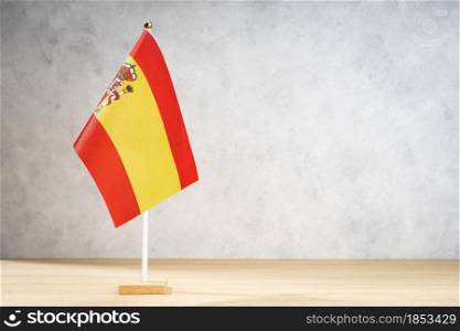 Spain flag on white textured wall. Copy space for text, designs or drawings