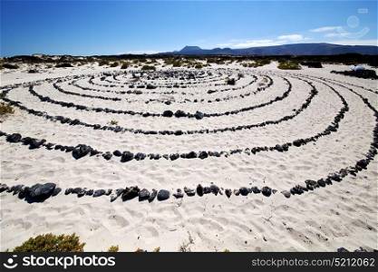 spain hill white beach spiral of black rocks in the lanzarote