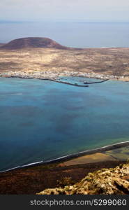 spain miramar del rio harbor rock stone sky cloud beach boat yacht water in lanzarote graciosa