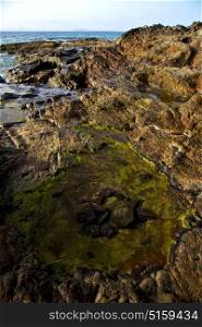 spain musk pond rock stone sky water coastline and summer in lanzarote