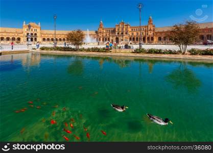 Spain Square or Plaza de Espana in Seville in the sunny summer day, Andalusia, Spain. Goldfish and ducks in the channel in the foreground
