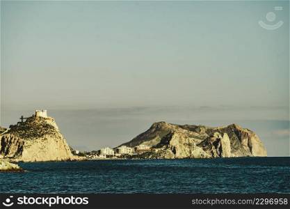 Spanish coastal landscpae with castle San Juan on cliff, Aguilas, Murcia region, Spain.. Coastline with castle on cliff, Aguilas, Spain