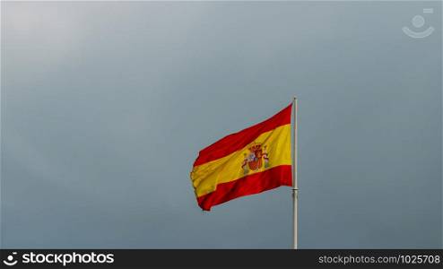 Spanish flag waving to the wind against the sky. Spanish flag waving to the wind against the sky.