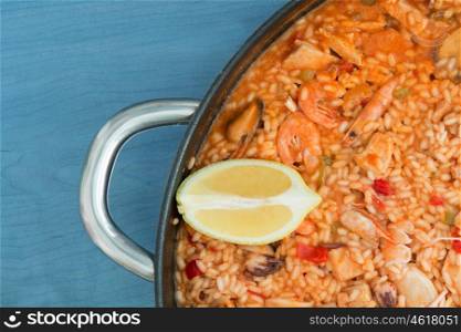Spanish food. Seafood paella on a wooden blue background