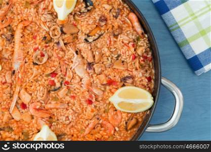 Spanish food. Seafood paella on a wooden blue background