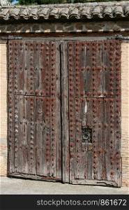 Spanish gate made of heavy wood studded with iron