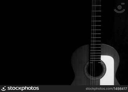 Spanish guitar on a black background in black and white