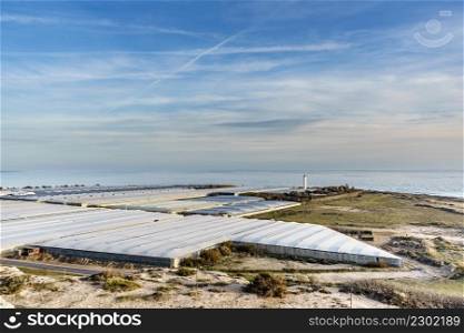 Spanish landscape and view of sea coast with many plastic greenhouses. Almeria region, Andalusia Spain.. Many plastic greenhouses in Almeria, Spain.