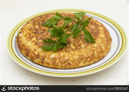 Spanish omelette with parsley on a white background