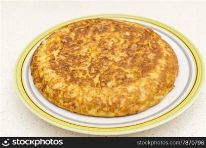 Spanish omelette with parsley on a white background