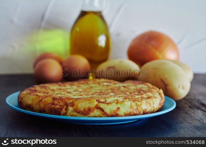 Spanish omelette with potato, egg and onion, accompanied by olive oil