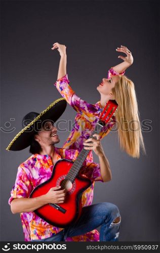 Spanish pair playing guitar and dancing