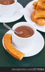 spanish pastry - cup of chocolate with churros. spanish pastry - churros