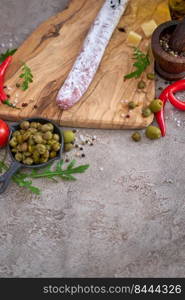 Spanish sausage fuet salami and vegetables on a domestic kitchen.. Spanish sausage fuet salami and vegetables on a domestic kitchen