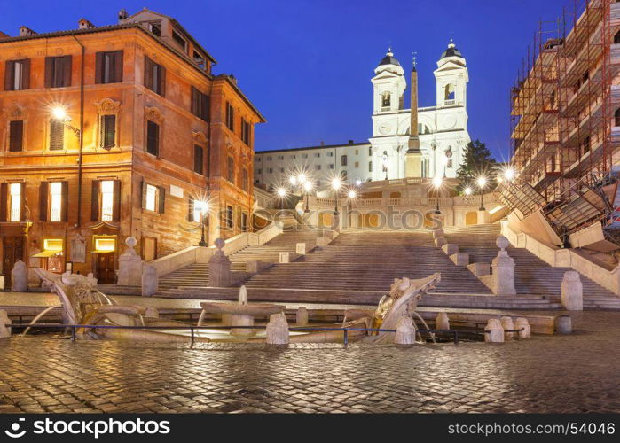 Spanish Steps at night, Rome, Italy.. Monumental stairway Spanish Steps, seen from Piazza di Spagna, and the Early Baroque fountain called Fontana della Barcaccia or Fountain of the ugly Boat during morning blue hour, Rome, Italy.