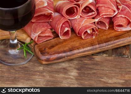 spanish tapas  - slices of cured pork ham jamon with  red wine. spanish tapas