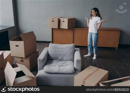 Spanish woman feels hard to move alone. Young lady is exhausted with boxes packing. Pretty girl in new apartment. Annoyed young lady has problem. Delivery service ordering concept.. Spanish woman feels hard to move alone exhausted with boxes packing. Delivery service ordering.