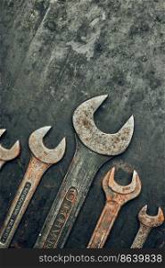 Spanners on steel surface. Old rusty wrenches for maintenance. Mechanic hardware tools to fix. Technical tools background with copy space