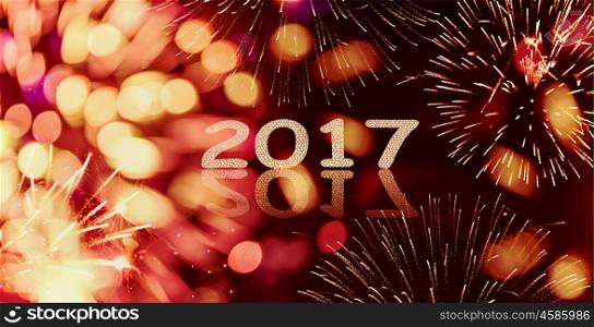 Sparkle and bokeh New year firework background with written 2017, banner