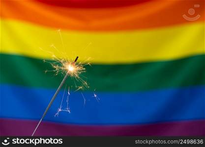 Sparkler and Gay pride LGBT flag.