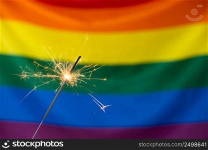 Sparkler and Gay pride LGBT flag. Pride month celebration party.