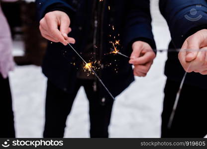 Sparkler background. Christmas and new year sparkler holiday background. people burn Bengal lights. people burn Bengal lights. Sparkler background. Christmas and new year sparkler holiday background.