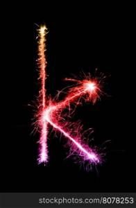 Sparkler firework light alphabet k (Small Letters) at night background