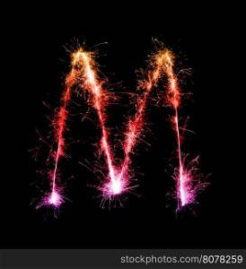 Sparkler firework light alphabet M (Capital Letters) at night background