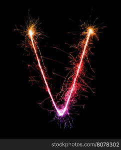 Sparkler firework light alphabet V at night background