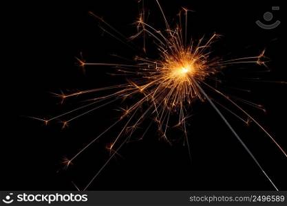 Sparkler isolated on black background. Burning bengal fire christmas party element.