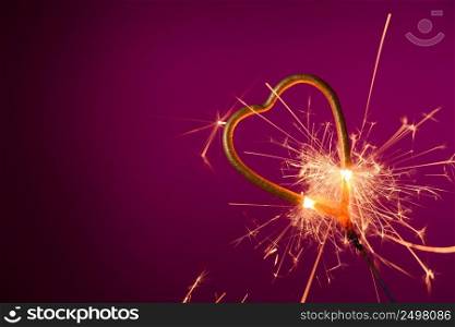 Sparkler love heart shape burning with many spakrs