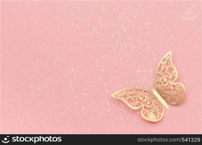 Sparkles glitter and gold tracery butterfly on pink pastel trendy background. Festive background, template.. Sparkles glitter and gold tracery butterfly on pink pastel trendy background. Festive background, template