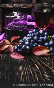 Sparkling red wine and grapes. Young red wine in the glass from the autumn harvest of grapes.Copy space