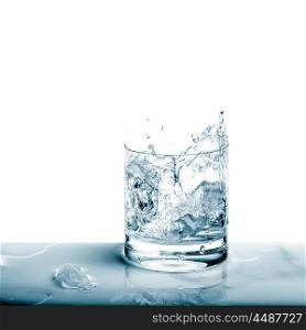Sparkling water in broken glass over white background. Fresh cold drink