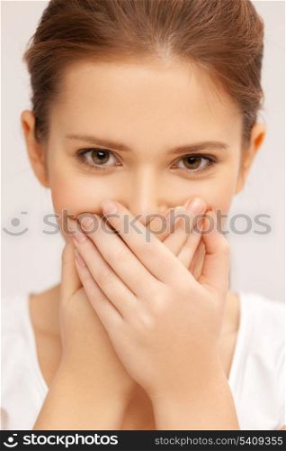 speak no evil concept - face of beautiful teenage girl covering her mouth