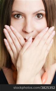 Speak no evil concept. Surprised woman face wide eyed covering her mouth with hands