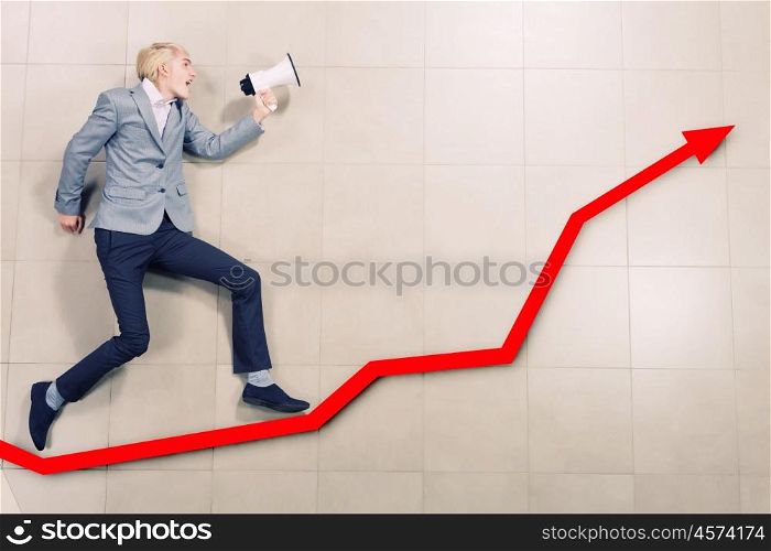 Speaker man. Young businessman running on graph with megaphone in hand