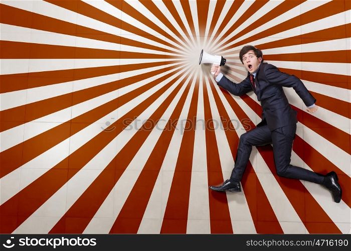 Speaker man. Young businessman running with megaphone in hand