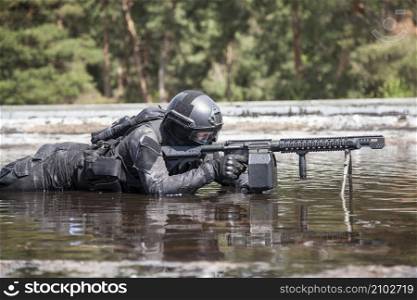 Spec ops police officer SWAT in action in the water. Spec ops police officer