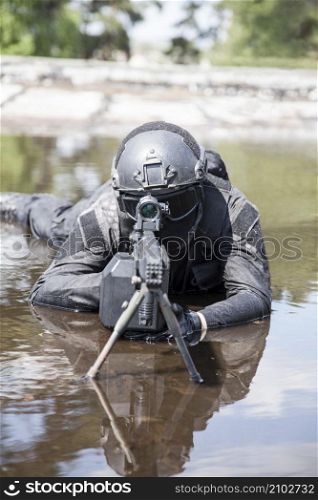 Spec ops police officer SWAT in action in the water. Spec ops police officer