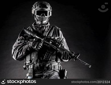 Spec ops police officer SWAT in black uniform and face mask. Spec ops police officer SWAT