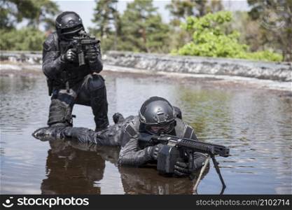 Spec ops police officers SWAT in action in the water. Spec ops police officers SWAT in the water